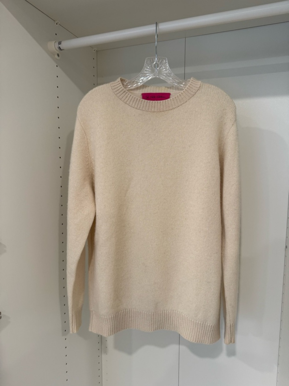 The Elder Statesman cream sweater with pink label